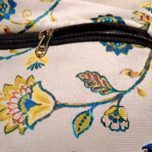 Floral Haven Printed Suede Premium Fabric Cushion Cover  Floral pattern with a mix of blue, yellow and orange flowers on a white background