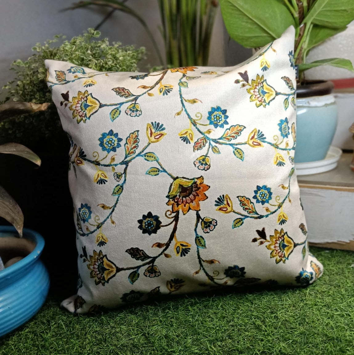 Floral Haven Printed Suede Premium Fabric Cushion Cover  Floral pattern with a mix of blue, yellow and orange flowers on a white background